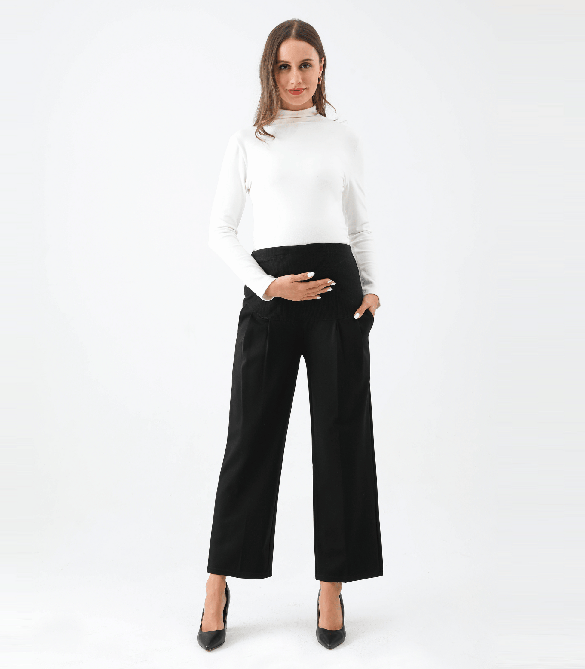 Woman wearing a white top and black wide-leg pants on a white background