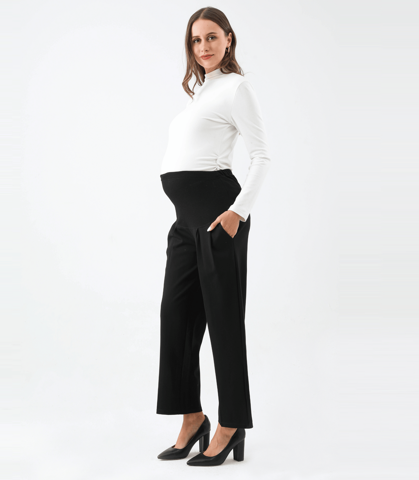 Woman wearing a white top and black pants on a white background