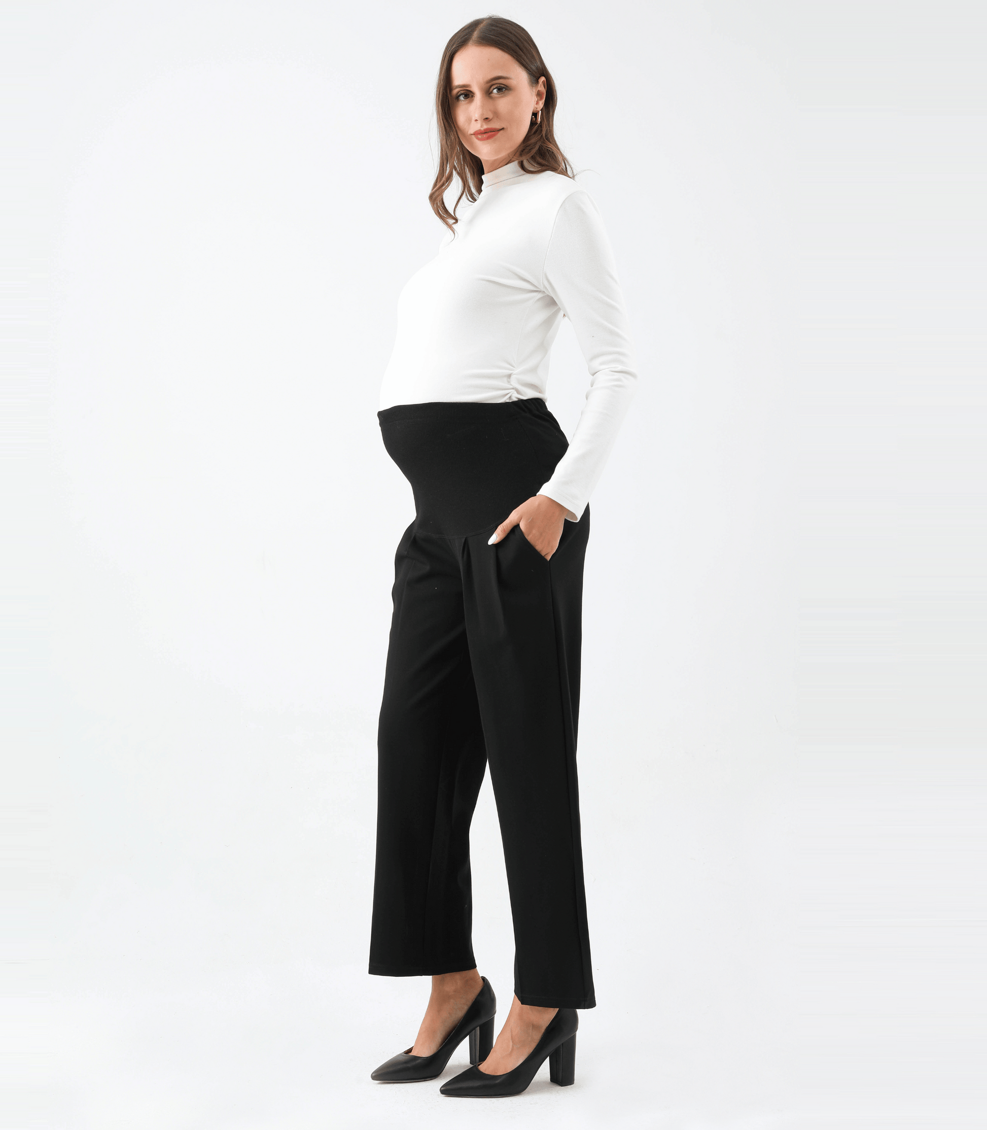 Woman wearing a white top and black pants on a white background