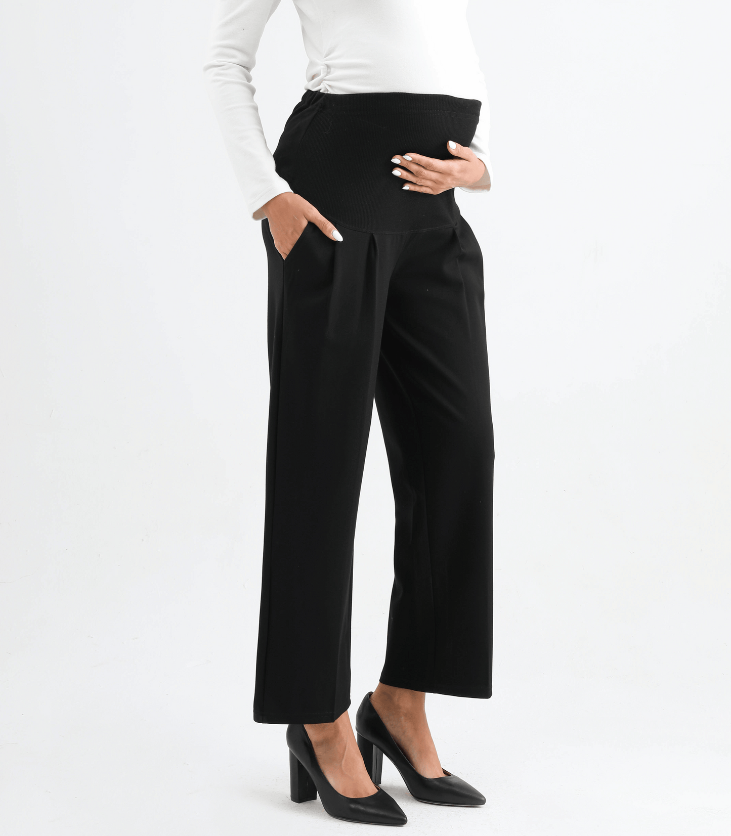 Black pants worn by a person on a white background