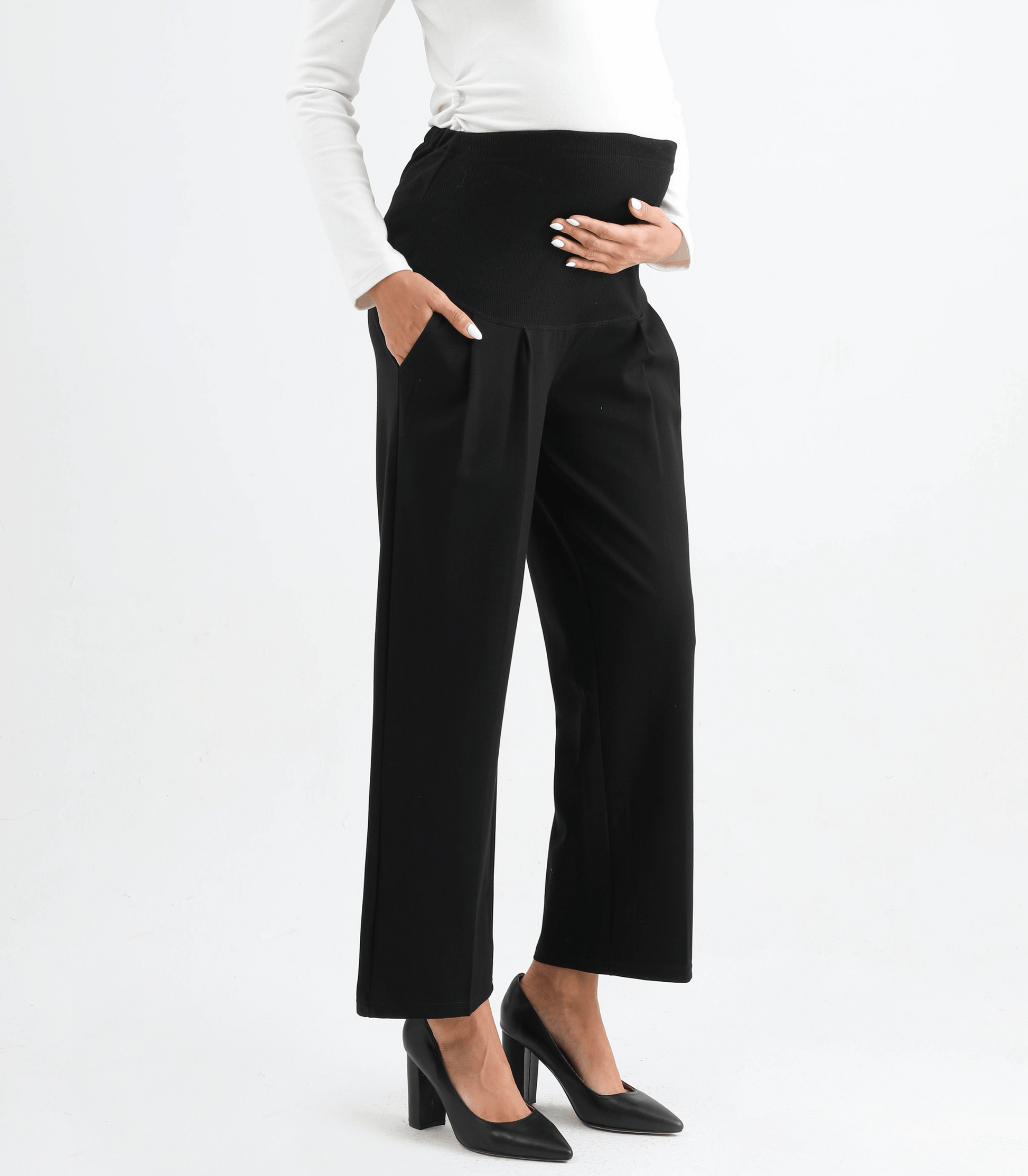 Black pants worn by a person on a white background