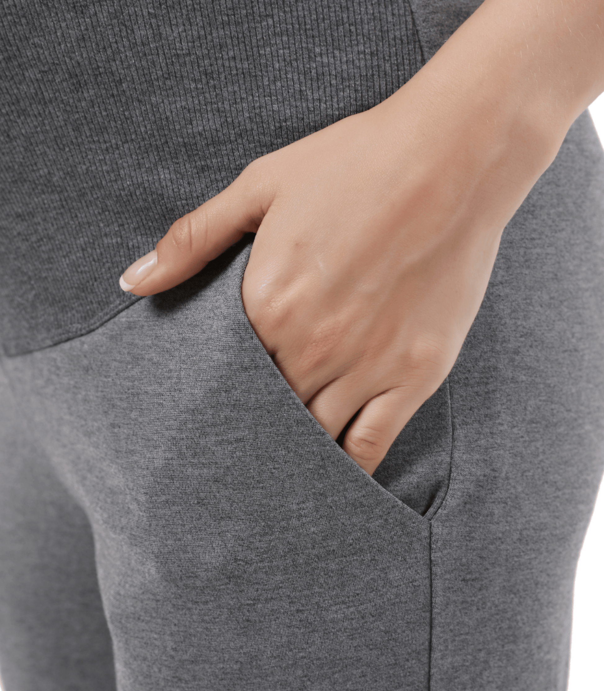 Gray sweatpants with a hand in one of the pockets on a neutral background