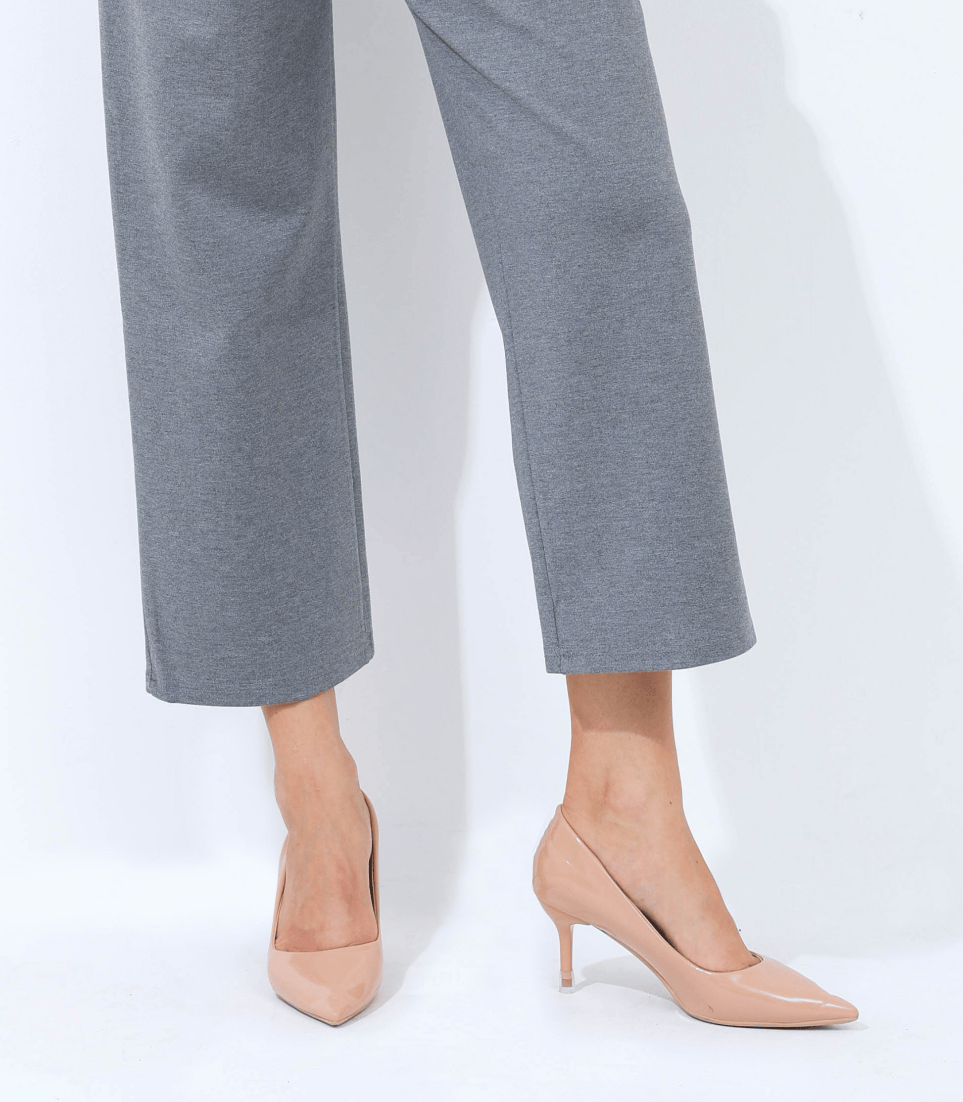 Gray pants and beige high-heeled shoes on a white background
