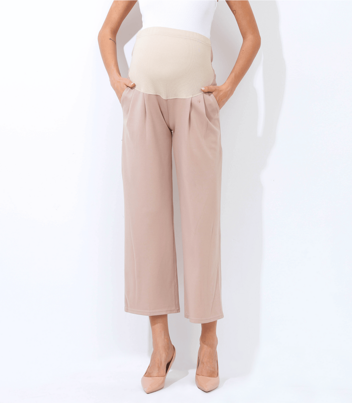 Beige wide-leg pants worn by a person on a white background