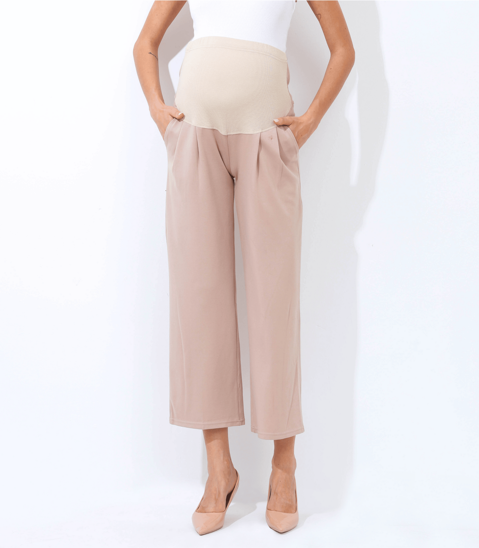 Beige wide-leg pants worn by a person on a white background