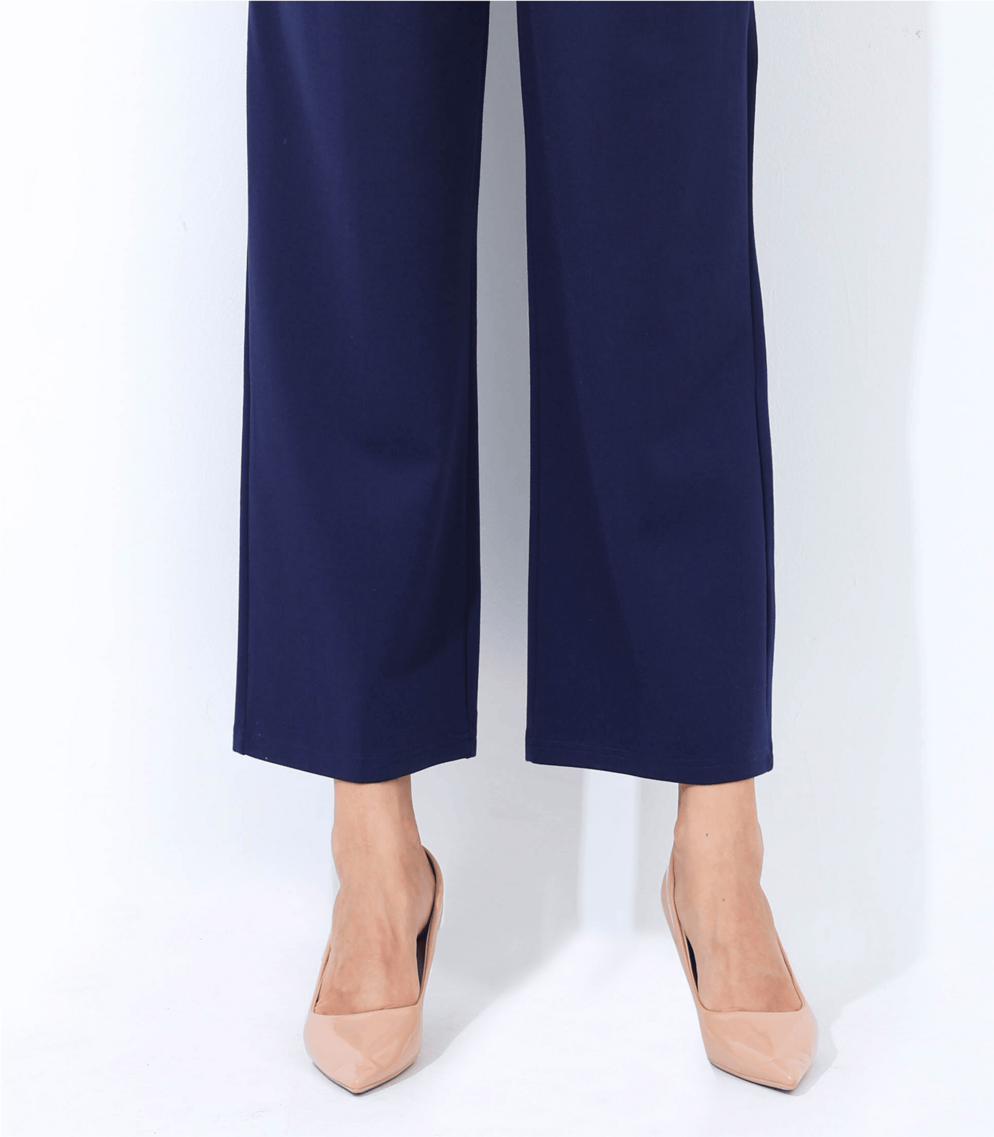 Navy blue pants worn by a person on a white background
