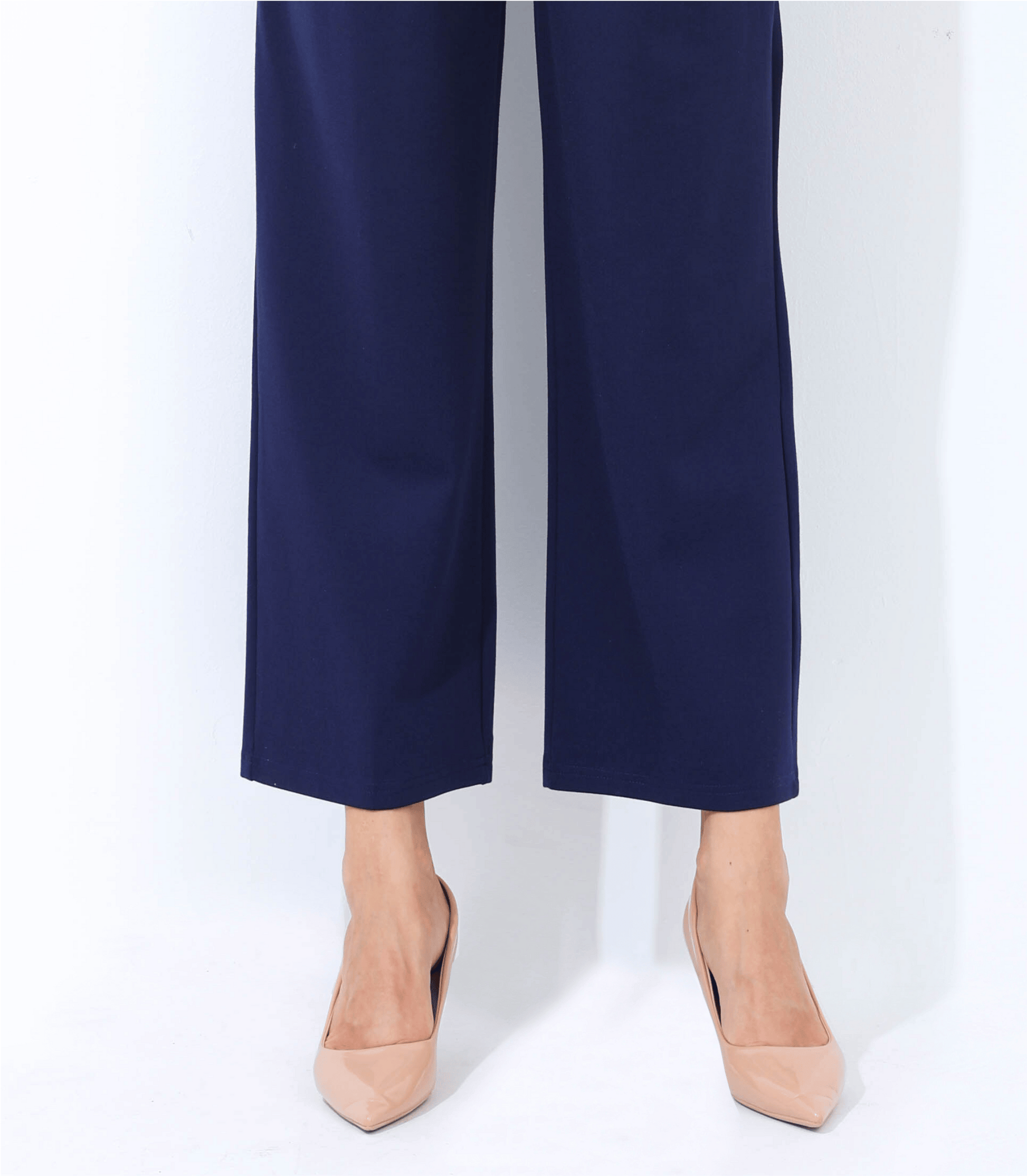 Navy blue pants worn by a person on a white background