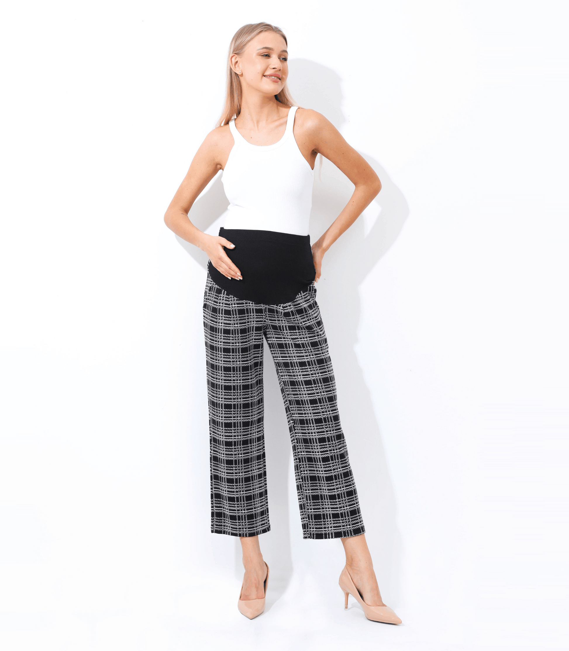 Woman wearing a white top and plaid pants on a white background