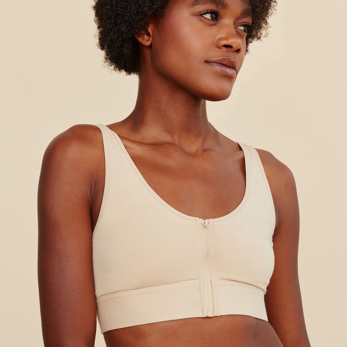 Beige cotton bralette with front zipper panel and smooth cups, scoop neckline