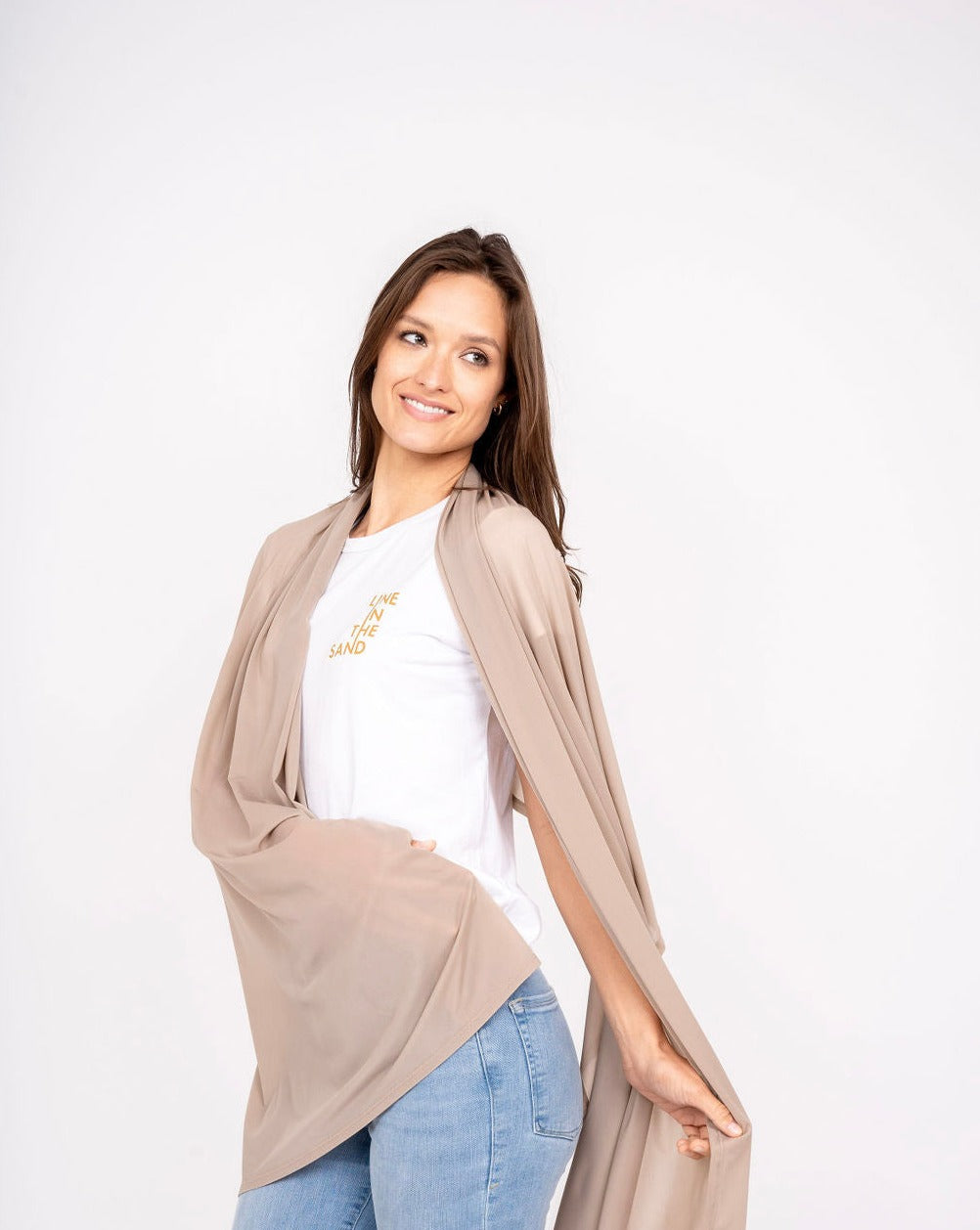 Beige mesh sun wrap worn open over the shoulder