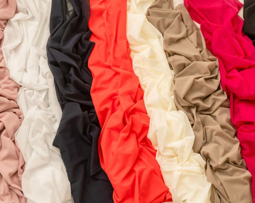 Mesh sun wrap fabric swatches in assorted colors, including white, black, beige, pink