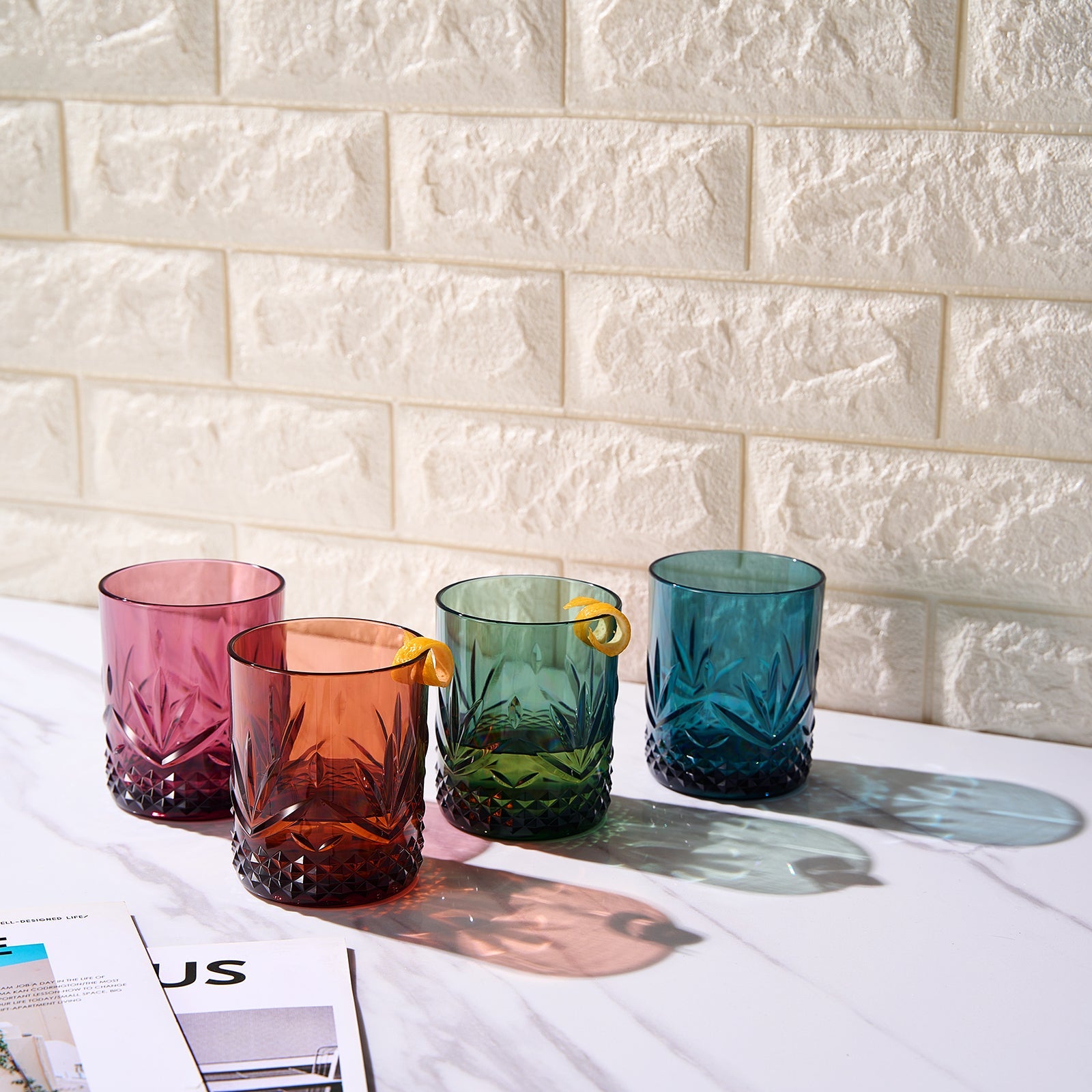 Four acrylic lowball glasses with leaf cuts and diamond base in pink, amber, green, blue