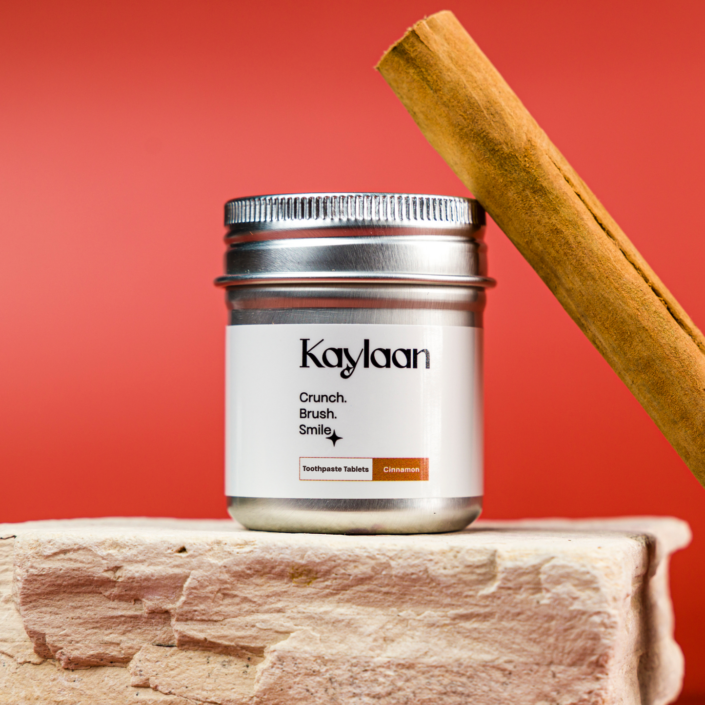 Kaylan non-fluoride cinnamon toothpaste tablets jar with silver lid and cinnamon stick