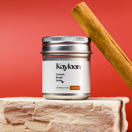 Kaylan non-fluoride cinnamon toothpaste tablets jar with silver lid and cinnamon stick