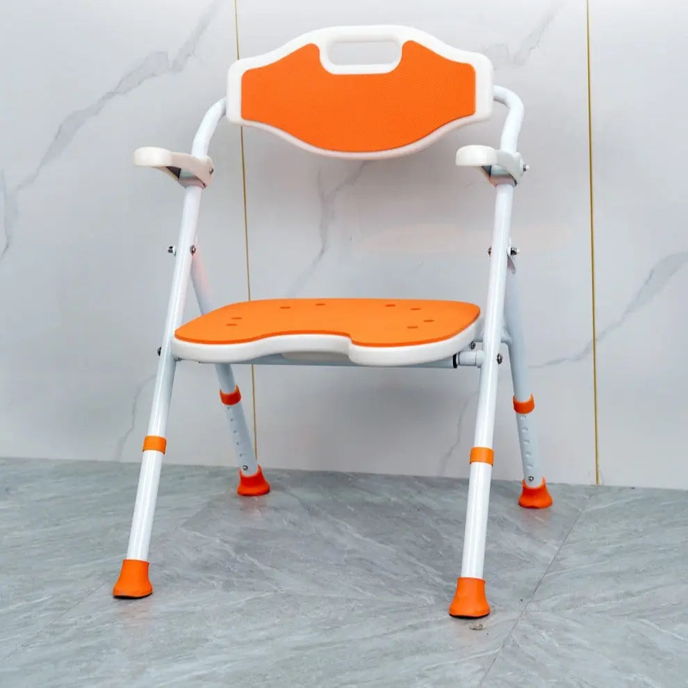 Orange and white adjustable shower chair against a tiled wall.