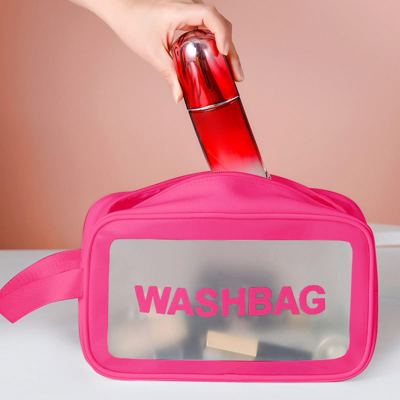 Pink frosted PVC washbag with translucent window and side strap, holding a red bottle