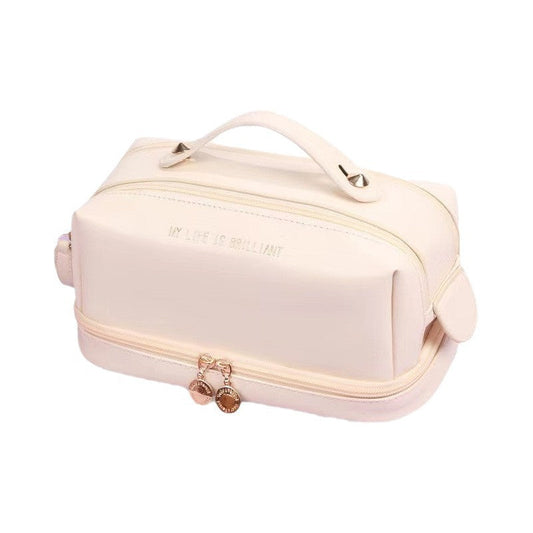 Off-white double-zip cosmetic bag with front zipper, hanging charm, and side handle