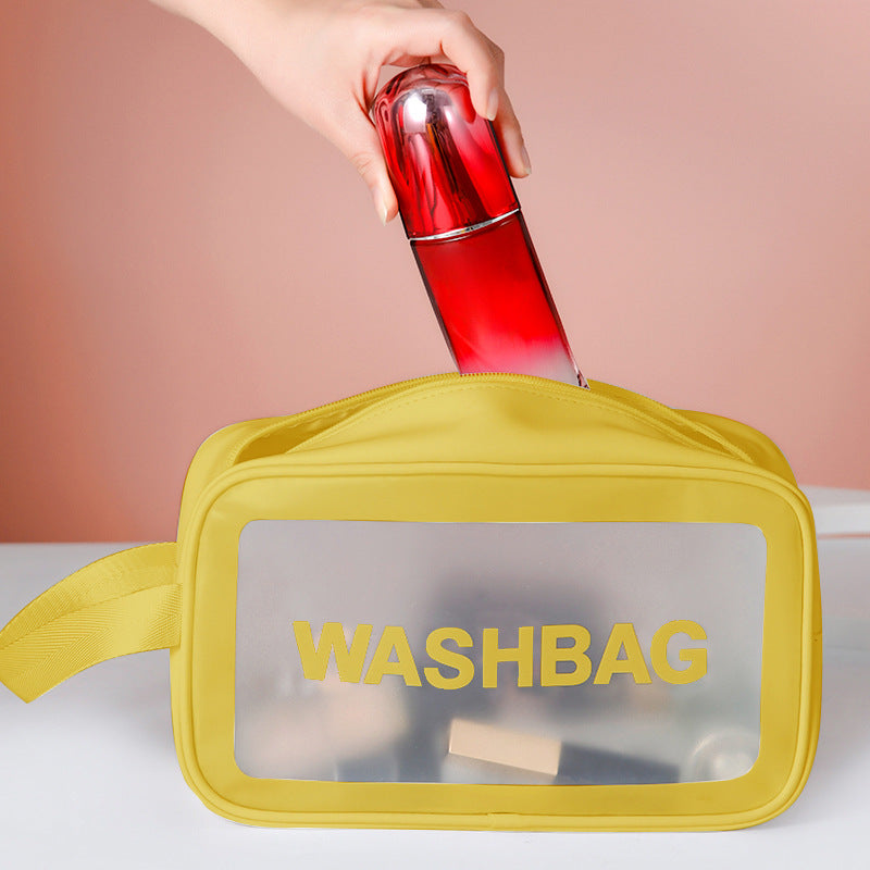 Yellow frosted PVC washbag with translucent window and side strap, holding a red bottle