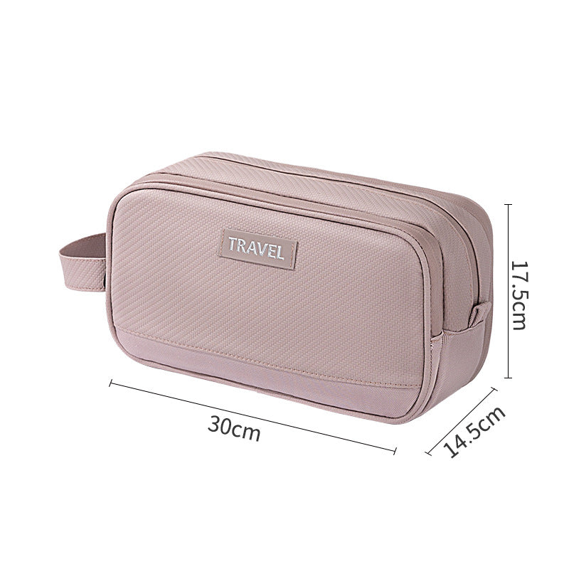 Pink travel toiletry bag with TRAVEL label, textured fabric and side handle