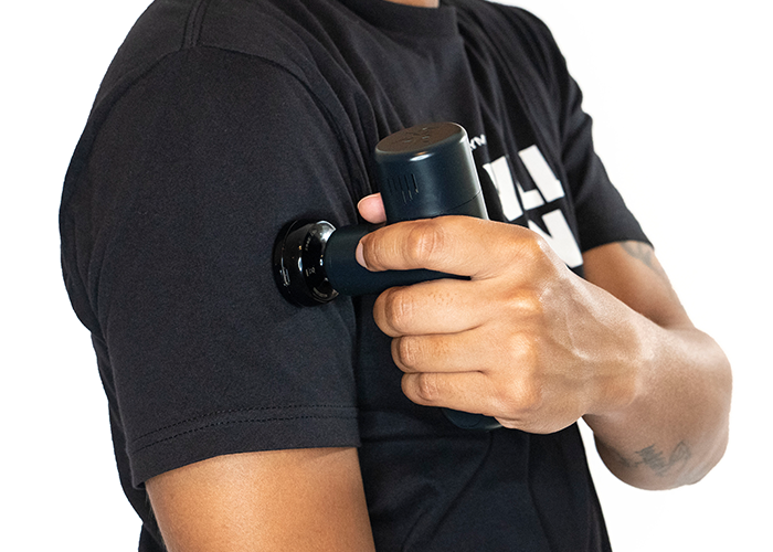 Black heated massage head in hand with angled connector and housing