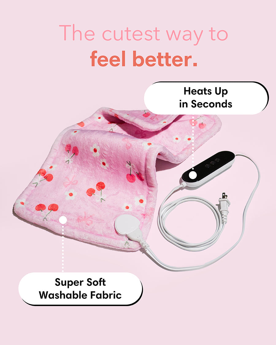 Pink cherry-pattern heating pad with black control device and cord