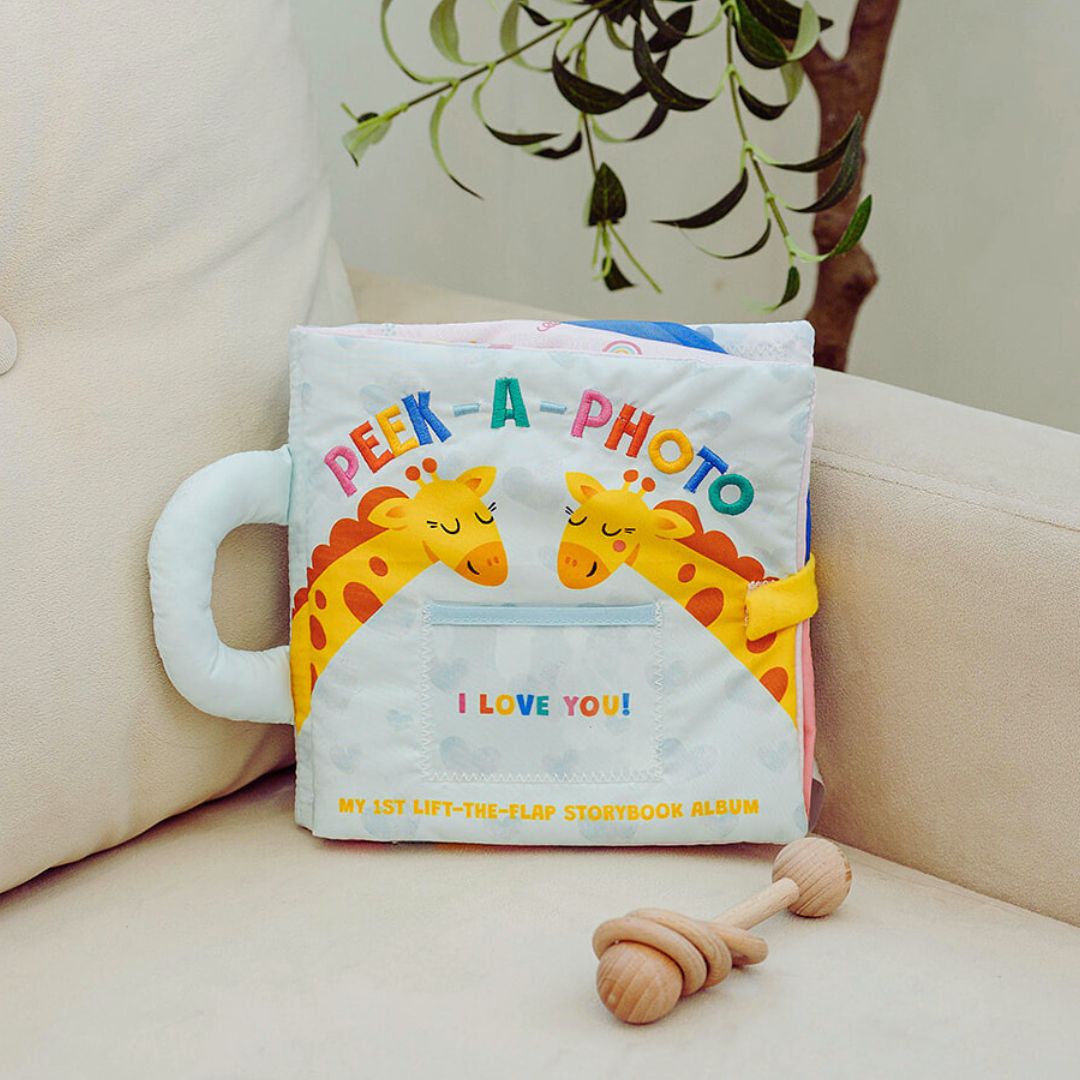 Peek-A-Photo cloth storybook with giraffe artwork and “I LOVE YOU!” on the front pocket.