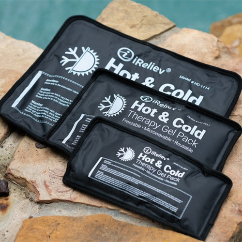 Black Hot & Cold therapy gel packs with iReliev branding on top of rocks.