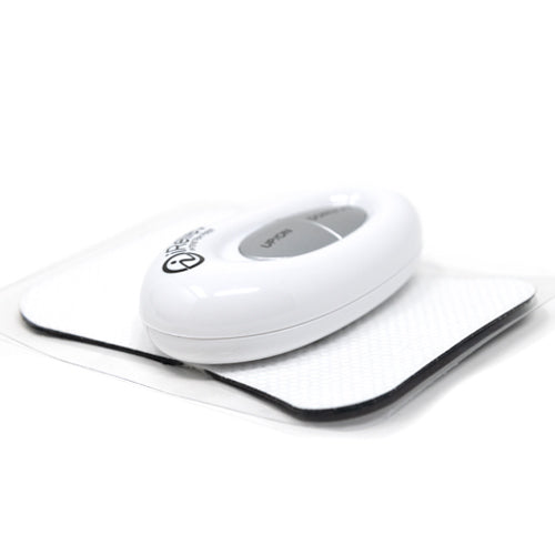 White controller unit lying on textured adhesive pain relief patch, close-up