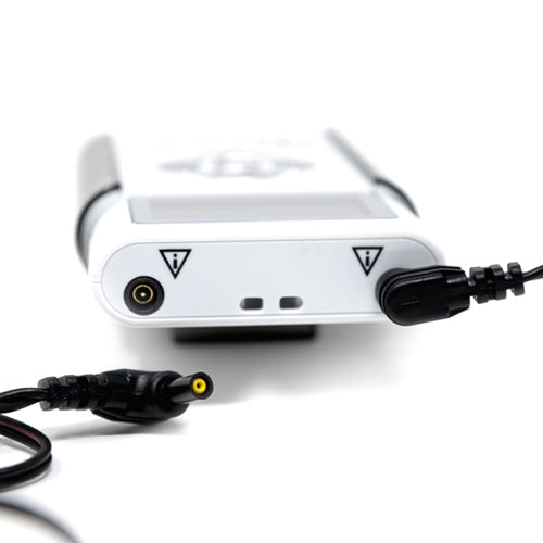 TENS unit with connected cable and yellow-tipped electrode plug