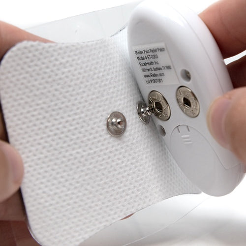 Textured adhesive pain relief pad with two silver electrodes and controller attachment