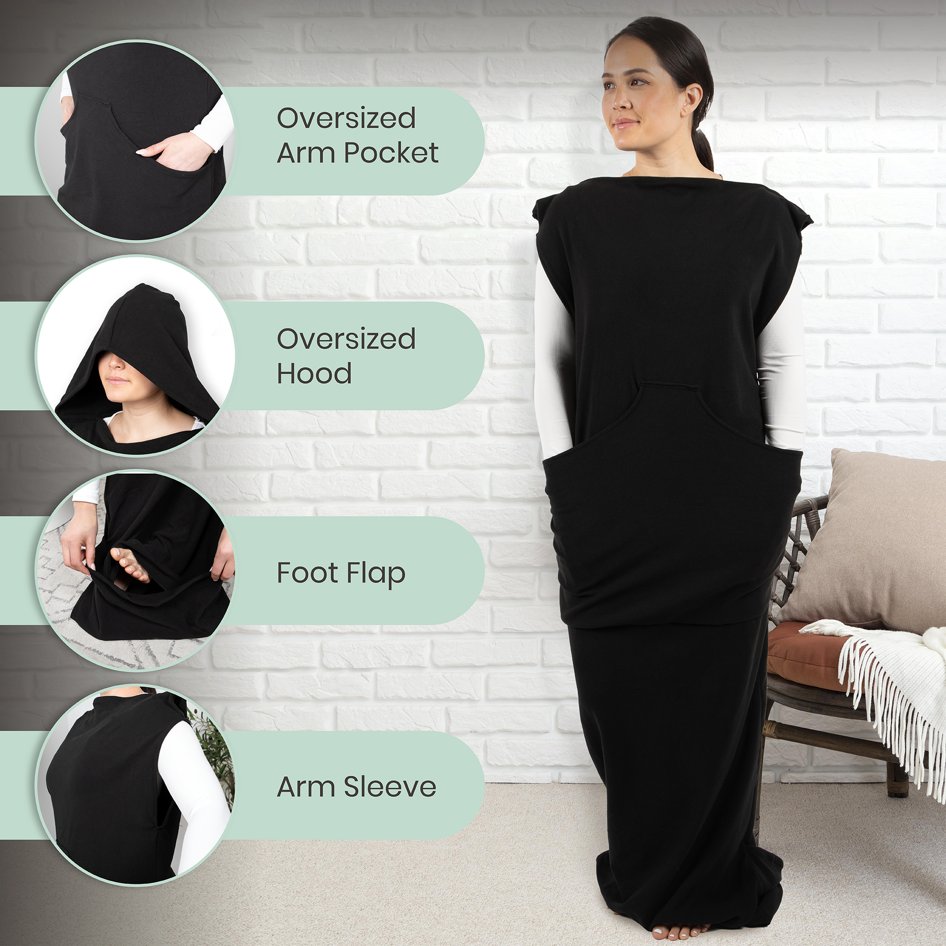 Black wearable hoodie-blanket with oversized hood, arm sleeves, and front pocket