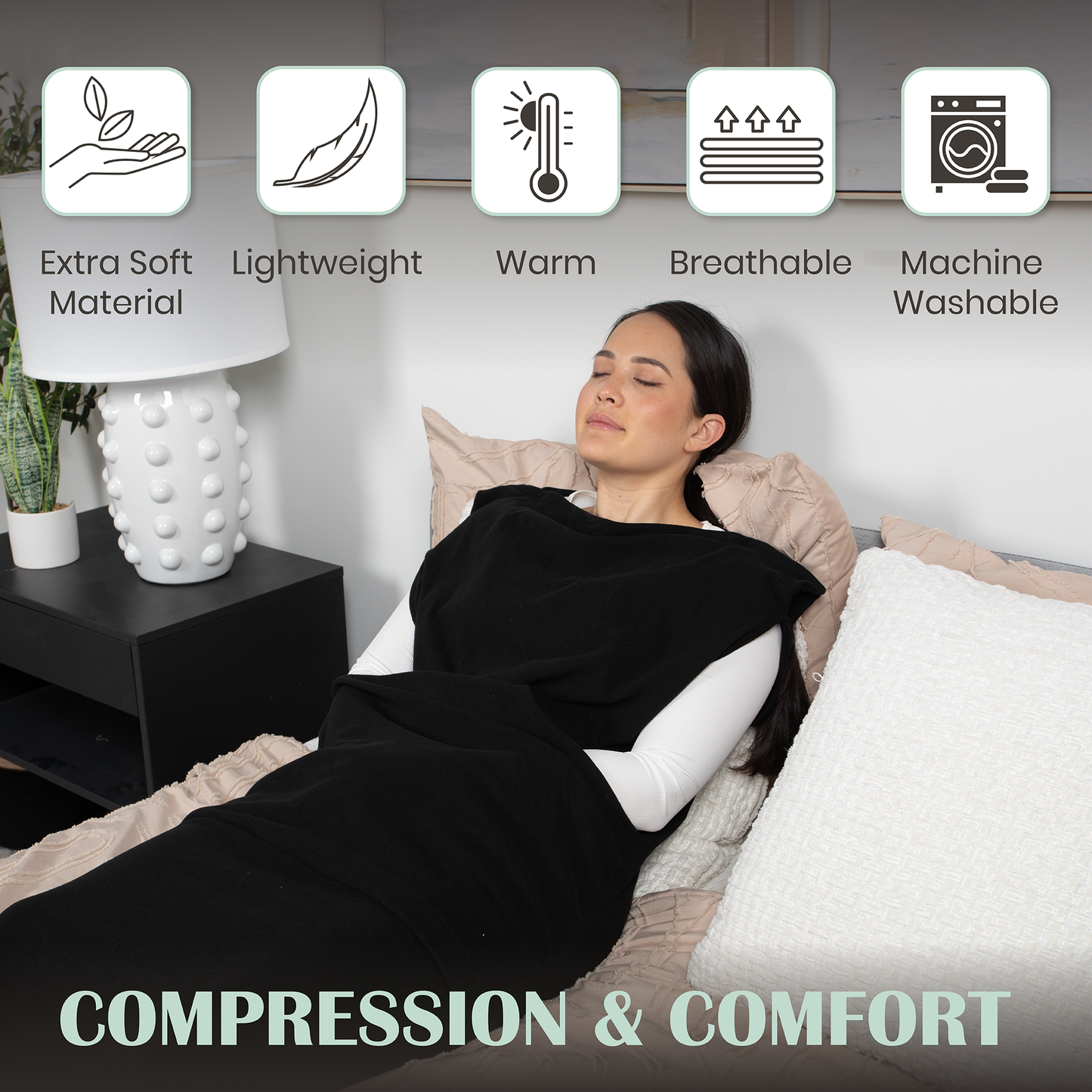 Black wearable compression hoodie-blanket with hood, covering torso, arms, and legs