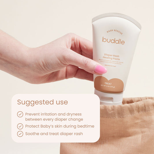 Diaper rash healing paste tube held in hand, white with buddle and Treat label