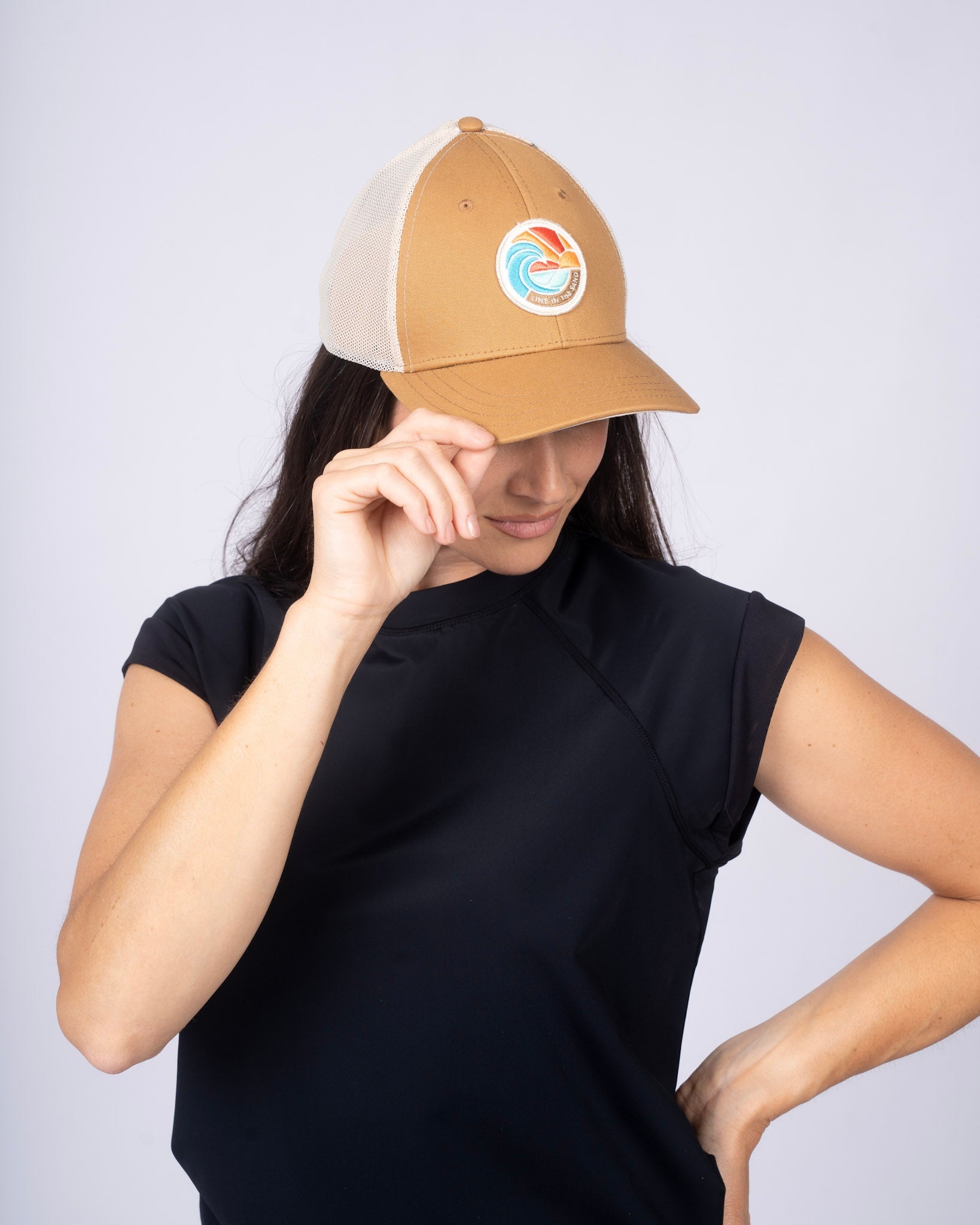 Tan retro patch baseball cap with white mesh side panels and front emblem