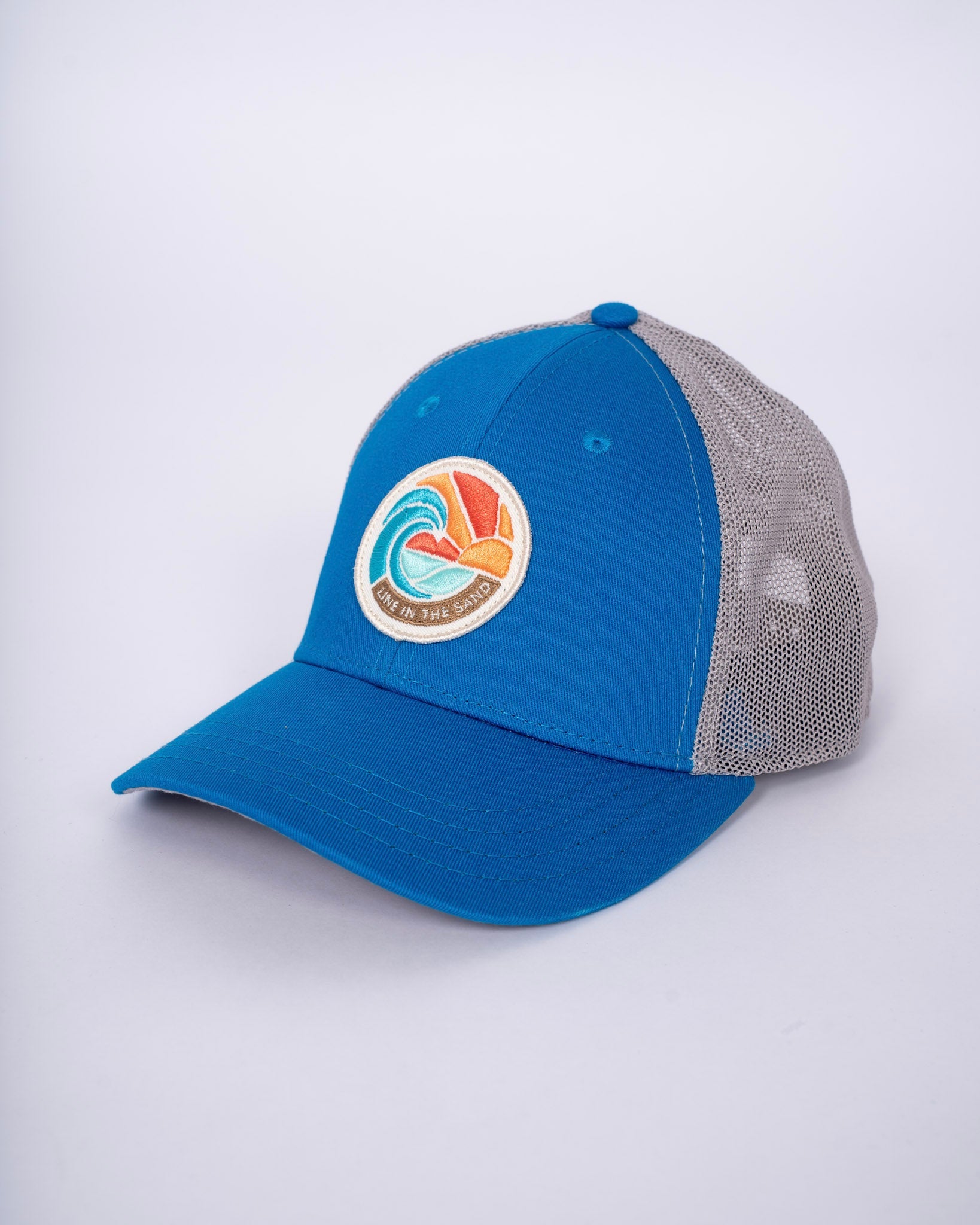 Blue retro patch baseball cap with gray mesh side panels and front circular emblem