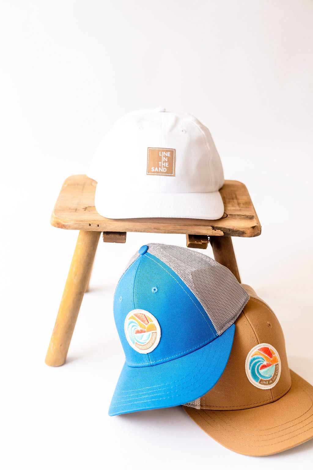 Light blue and tan retro patch baseball caps with front circular emblem