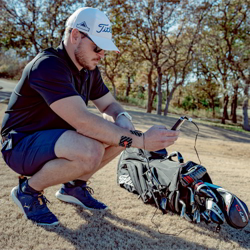 Muscle stimulator electrode pads on runner legs with controller connected by wires