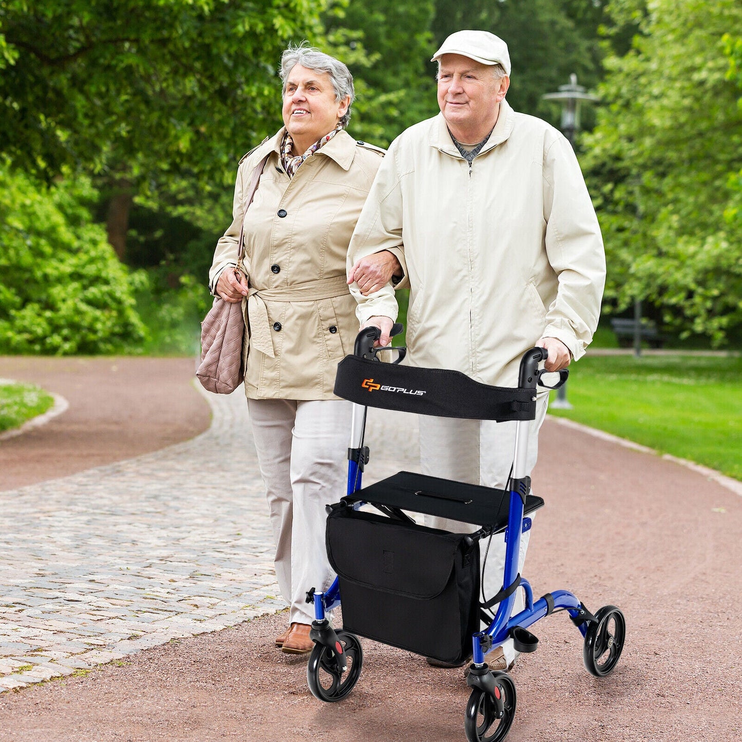 Two elderly people walking together, one using a walker, in a park setting.