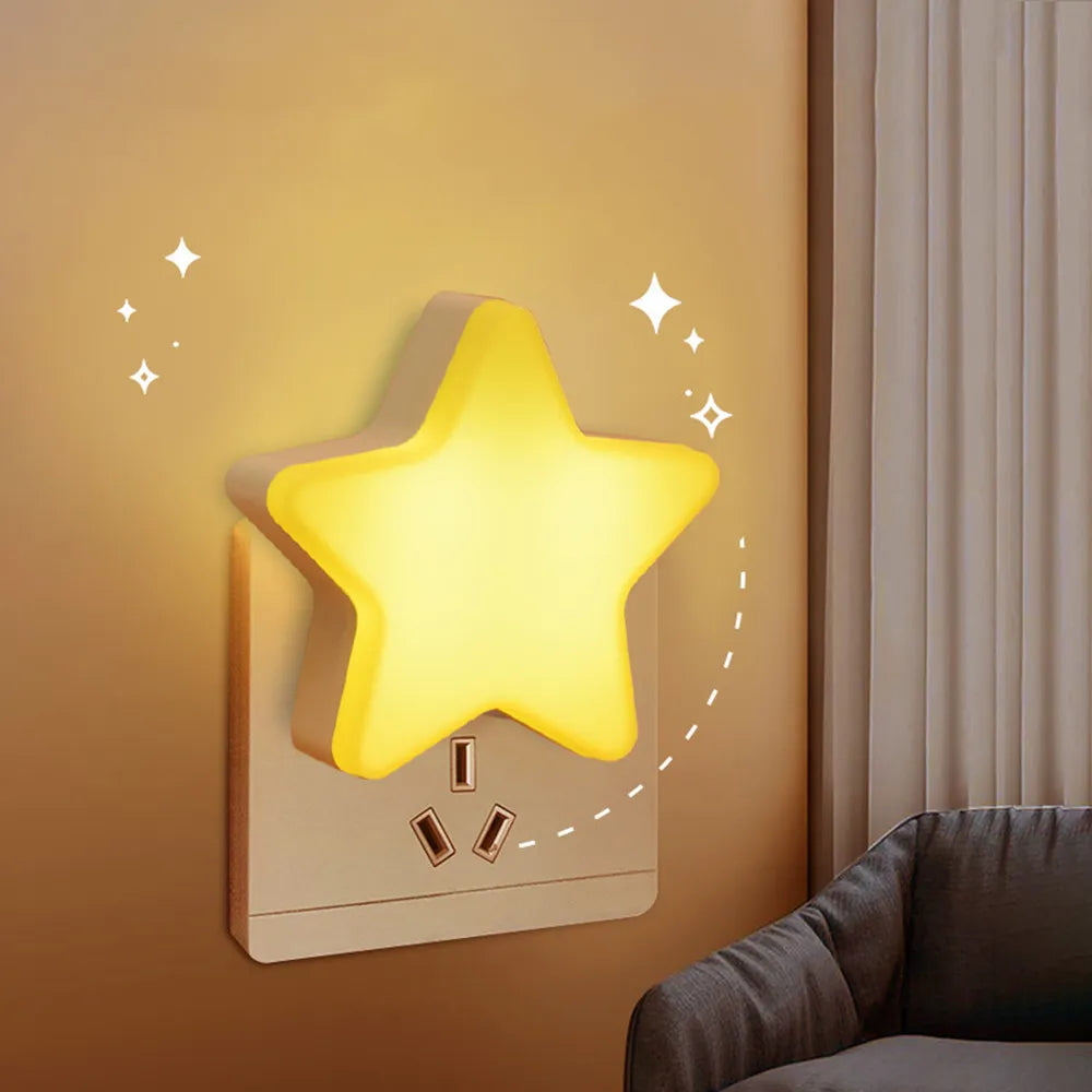 Yellow star LED plug-in night light shaped like a five-point star on a wall outlet.