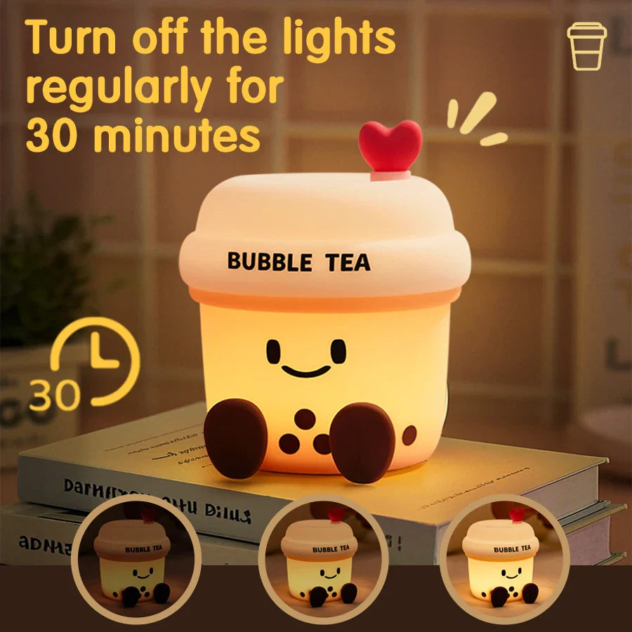 Kawaii bubble tea cup night light glowing on box insert, with heart lid and smiling face.