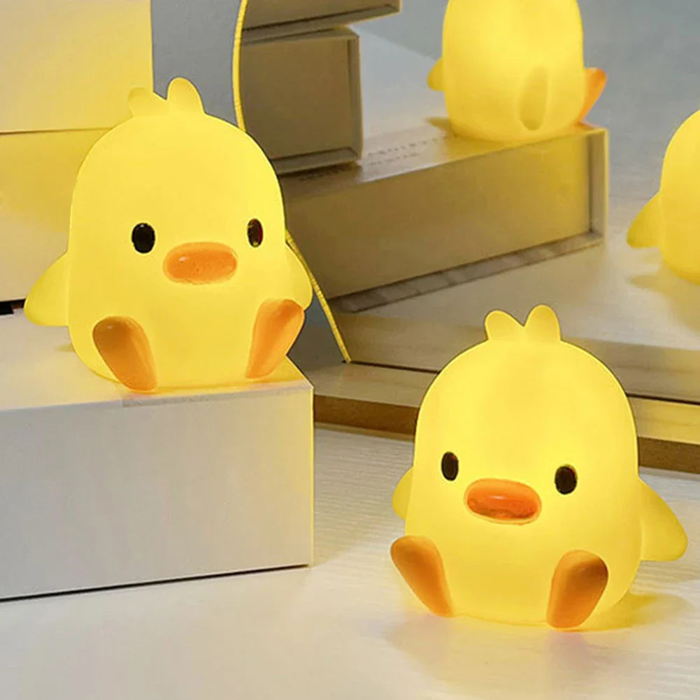 Duck-shaped night light, yellow chick figure with orange beak and black eyes