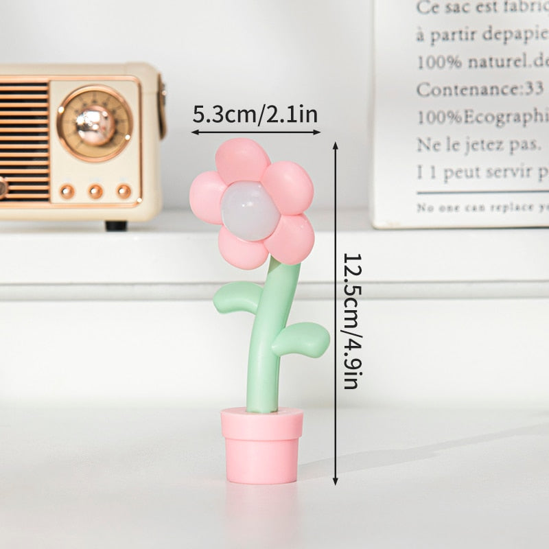 Pink and white flower night light with green stem and pink pot base