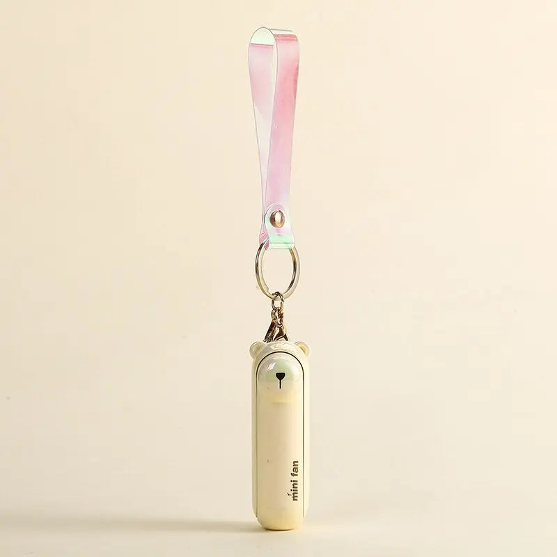 Translucent pale yellow animal-shaped handheld fan keychain with pink gradient strap