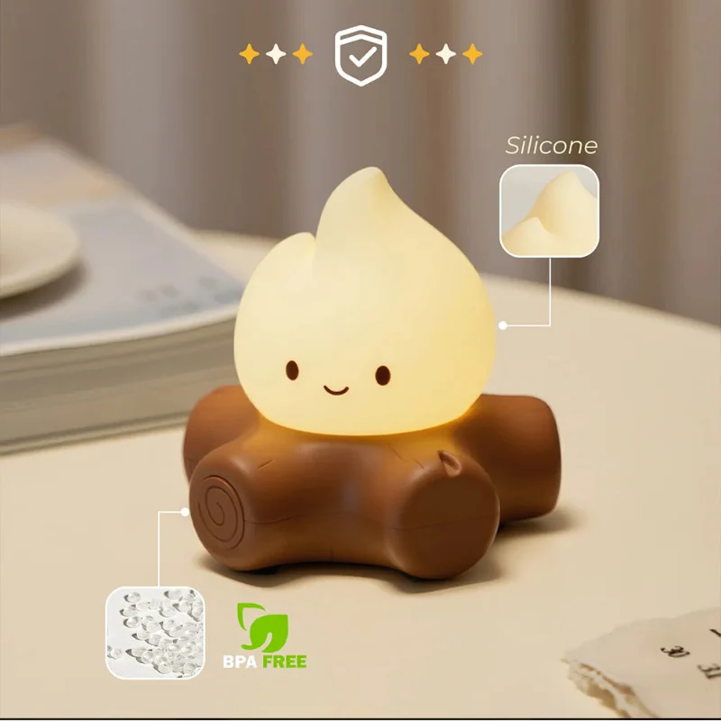 Cream flame night light with smiling face on brown log base, silicone feature shown