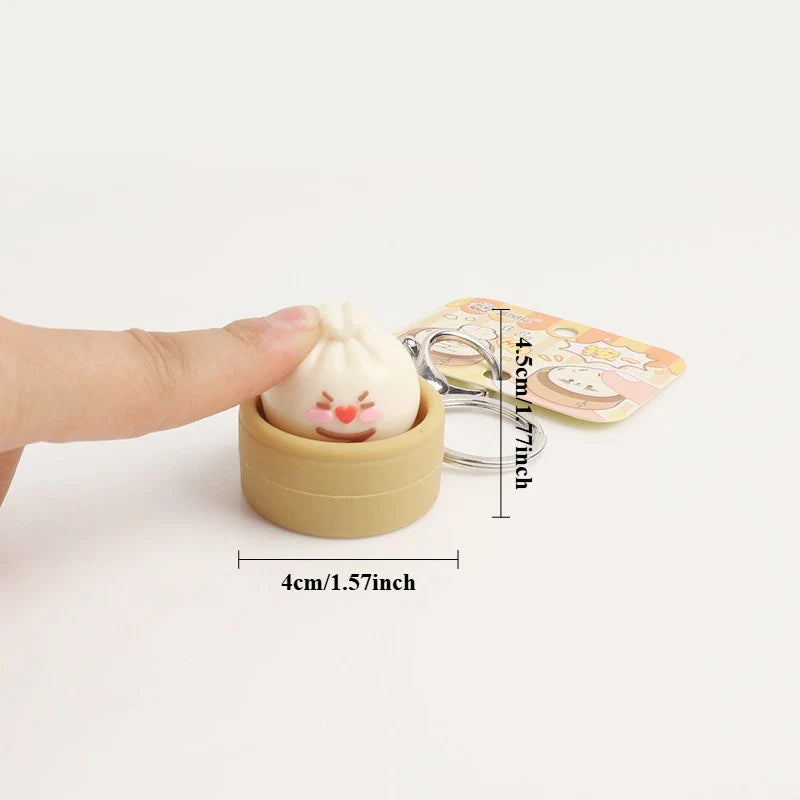 Dumpling fidget clicker keychain with tan container and cute face, metal ring