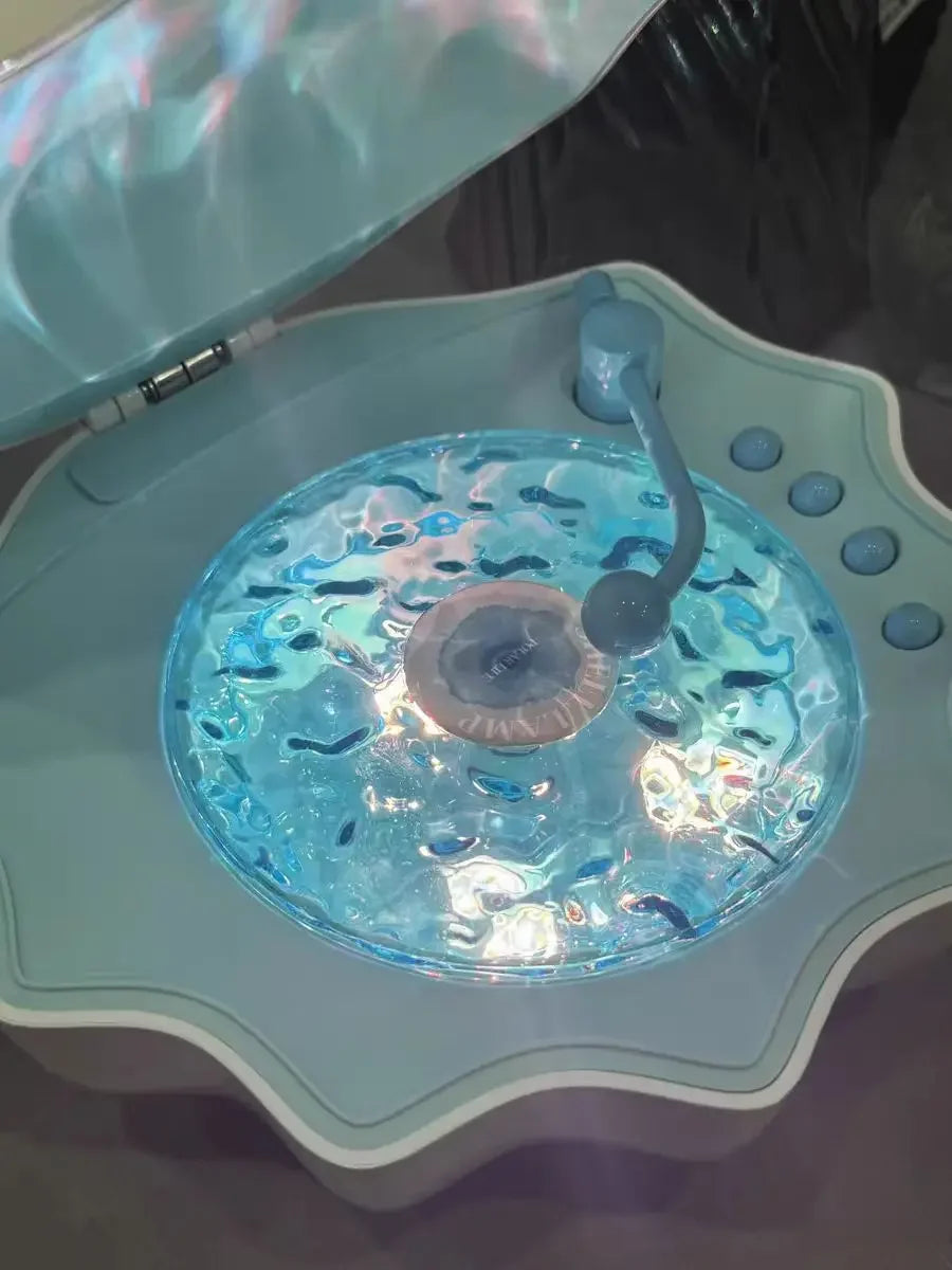 Blue shell Bluetooth speaker night light close-up: glowing light disc and control buttons