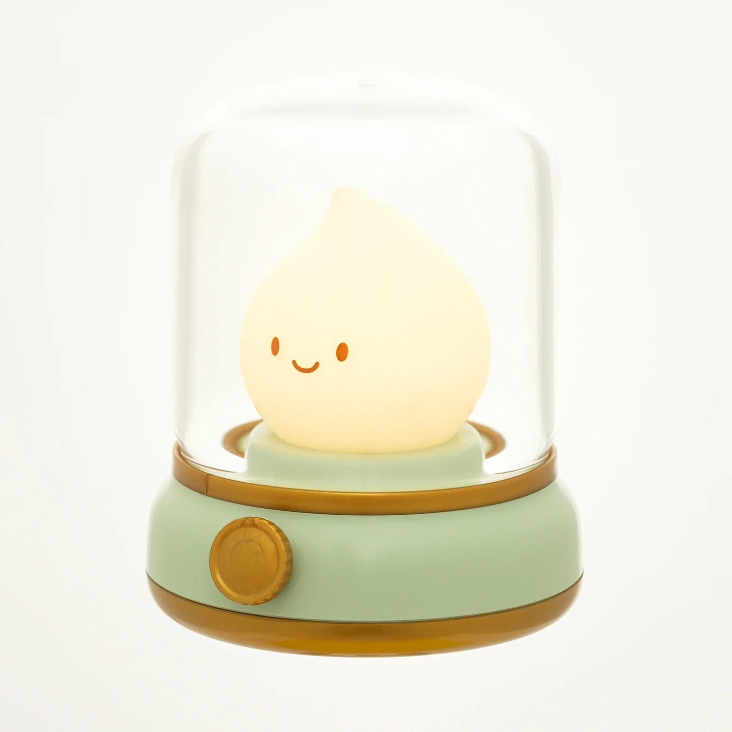 Green flame lantern night light with clear dome, glowing smiley flame, and gold trim.
