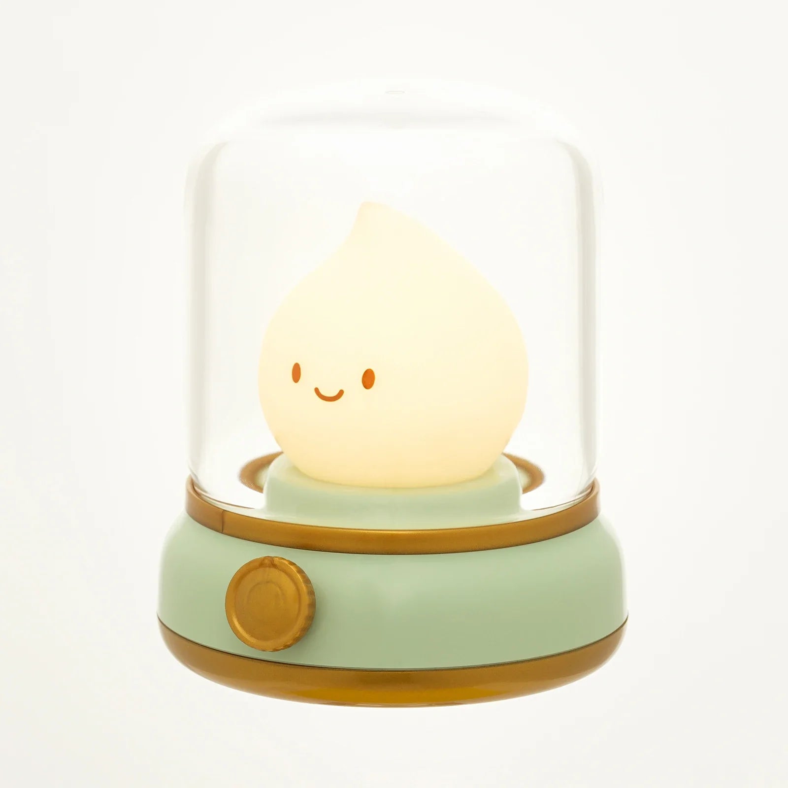 Green flame lantern night light with clear dome, glowing smiley flame, and gold trim.