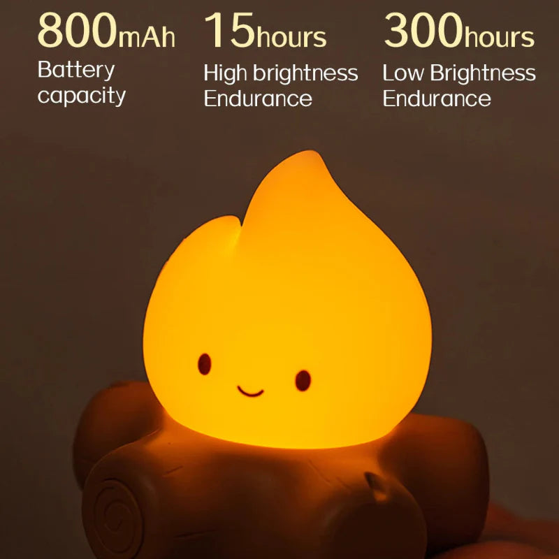 Bright glowing campfire night light with smiling flame face on brown log base