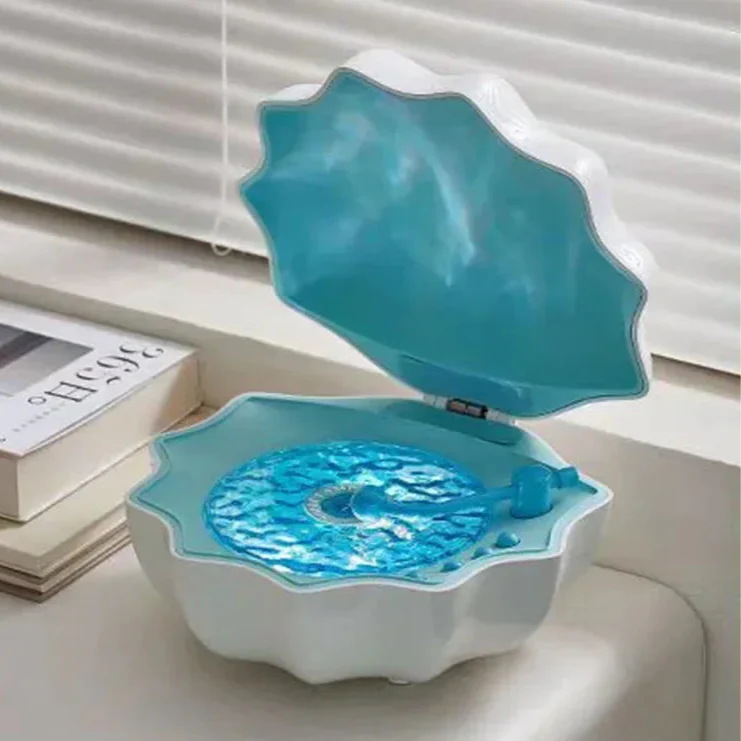 Blue shell Bluetooth speaker night light, open lid with glowing blue light panel
